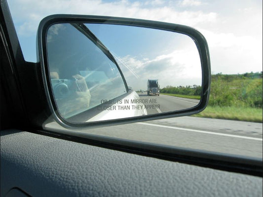 How Do I Properly Adjust My Side Mirrors to Eliminate Blind Spots?