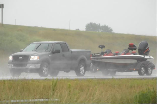 What Precautions Should You Take When Towing Your Pickup Truck in Extreme Weather Conditions, Such as High Winds or Heavy Rain?